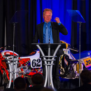 AMA Motorcycle Hall of Fame inductee Gary Davis shows off his Hall of Fame ring to the crowd.