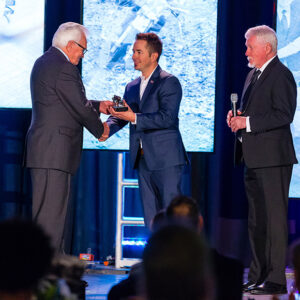 Tommy Hayden (right) accepting his brother Nicky Hayden’s hall of fame induction commemorative from AMA Motorcycle Hall of Famer Gary Mathers.